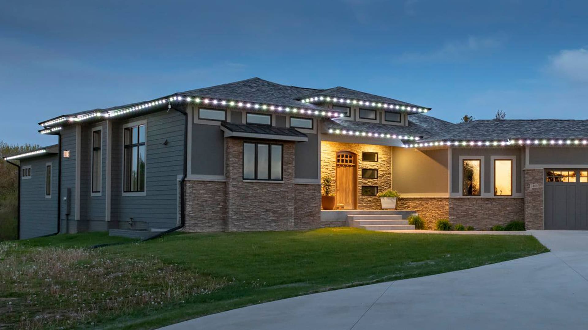 Permanent LED roofline lighting installed on a modern Colorado home at dusk.