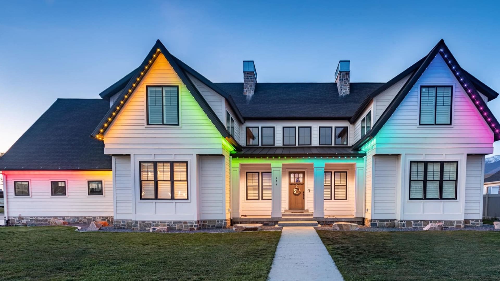 Color-changing permanent roofline lighting creating a multicolor display across a home. Color-changing permanent roofline lighting creating a multicolor display across a home.