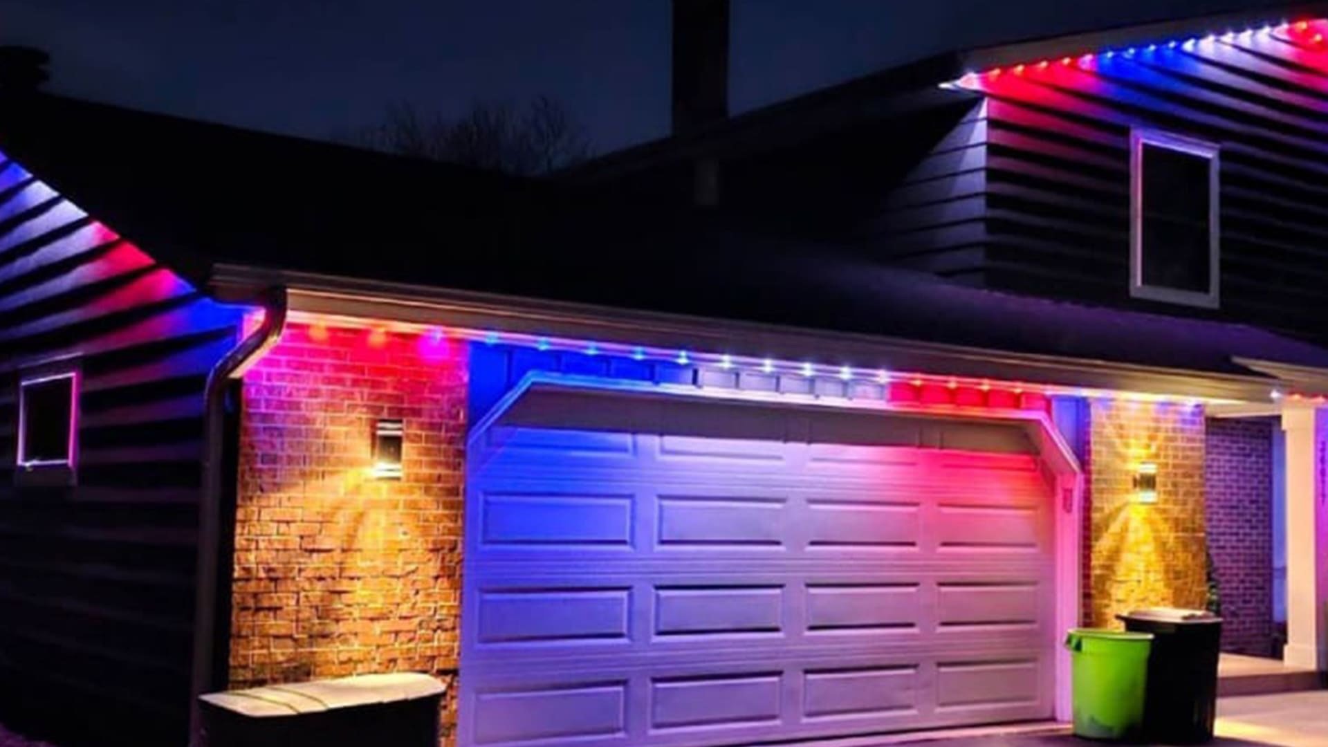 Red and blue permanent architectural lighting above a residential garage