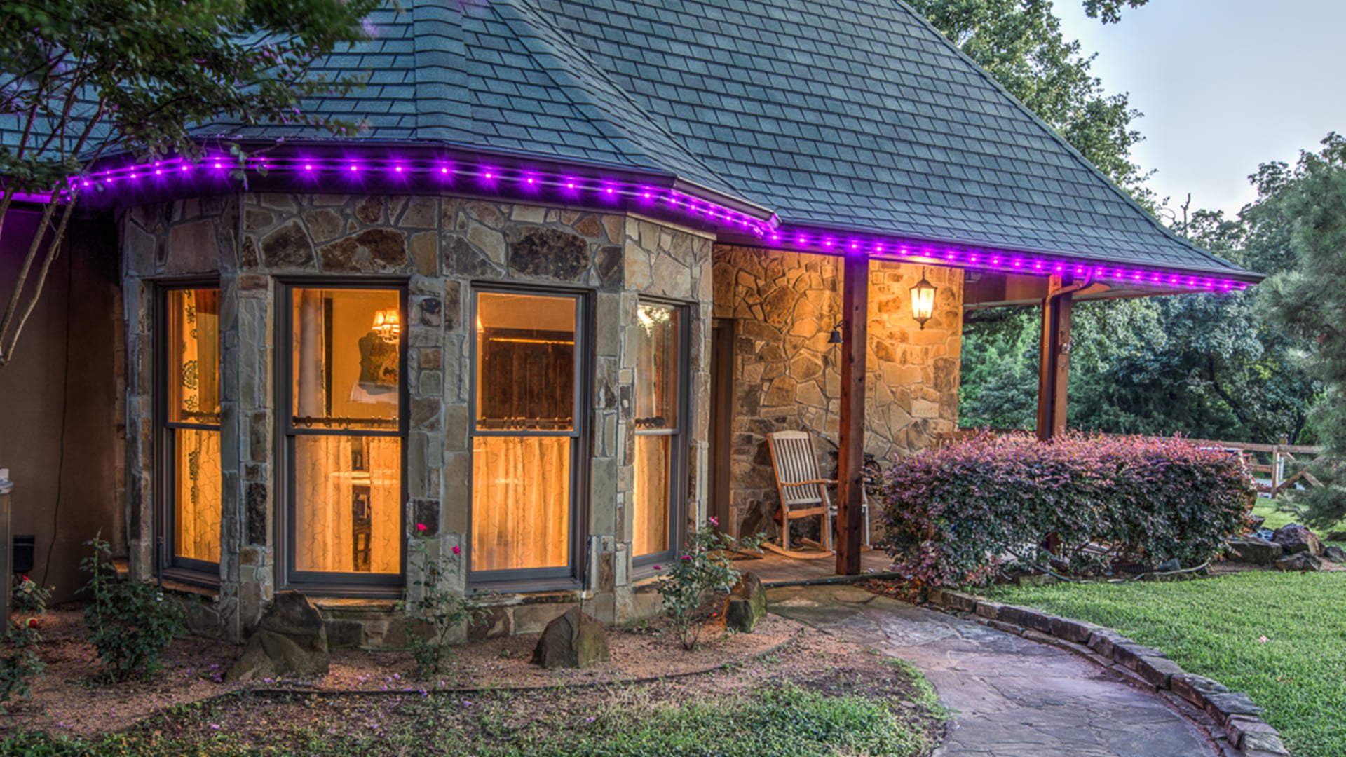 Warm white permanent architectural lighting highlighting a residential roofline