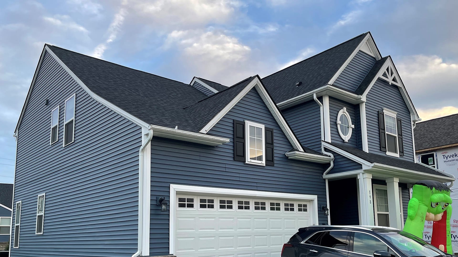Permanent roofline lighting installed discreetly along a home during the day