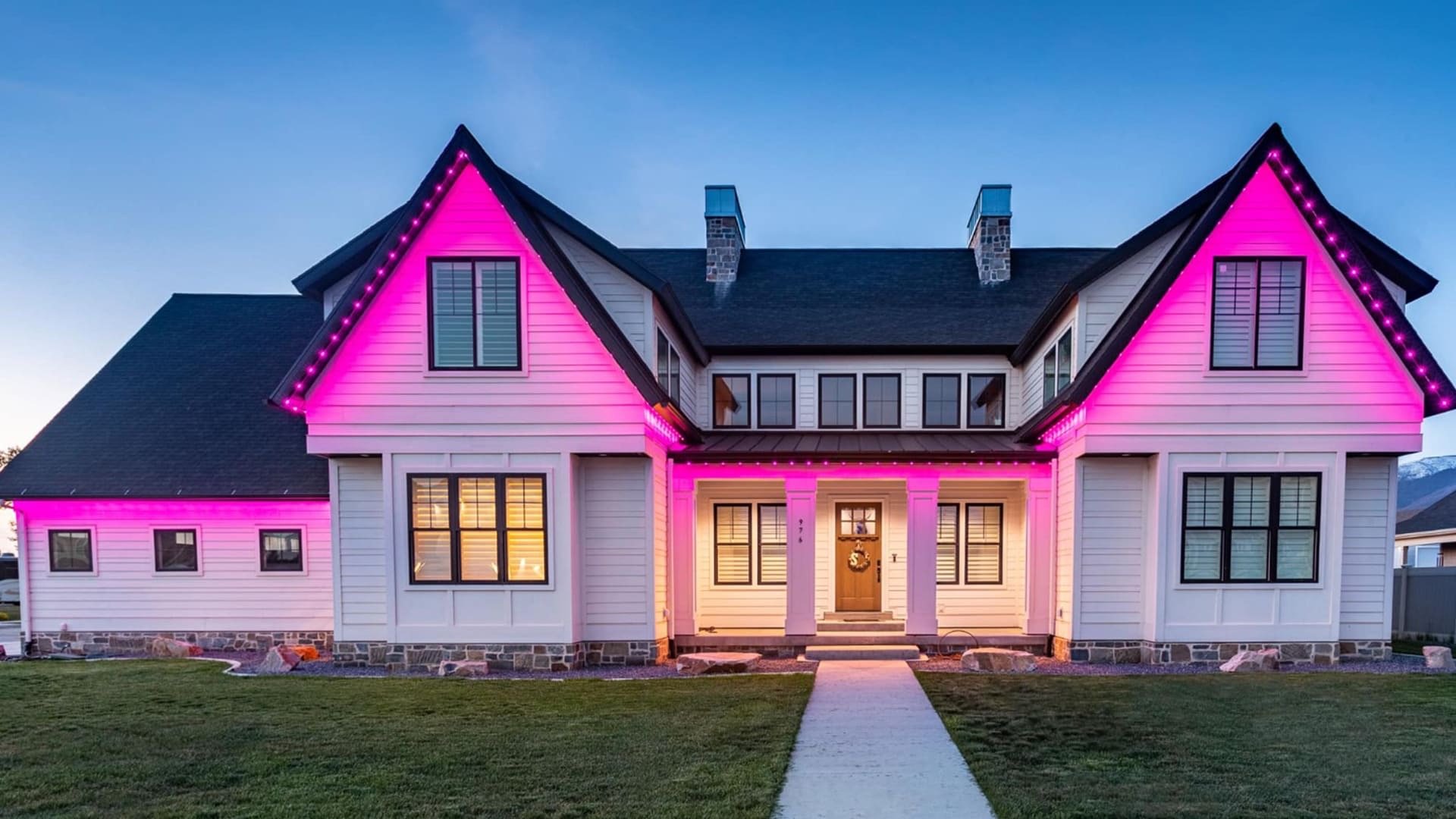 Pink permanent architectural lighting highlighting a residential roofline