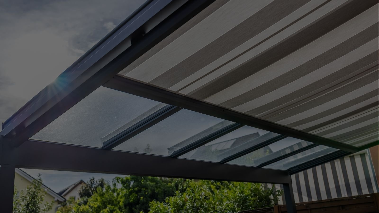 Modern outdoor living space in Greenwood Village with deck, covered patio, and permanent shade structure