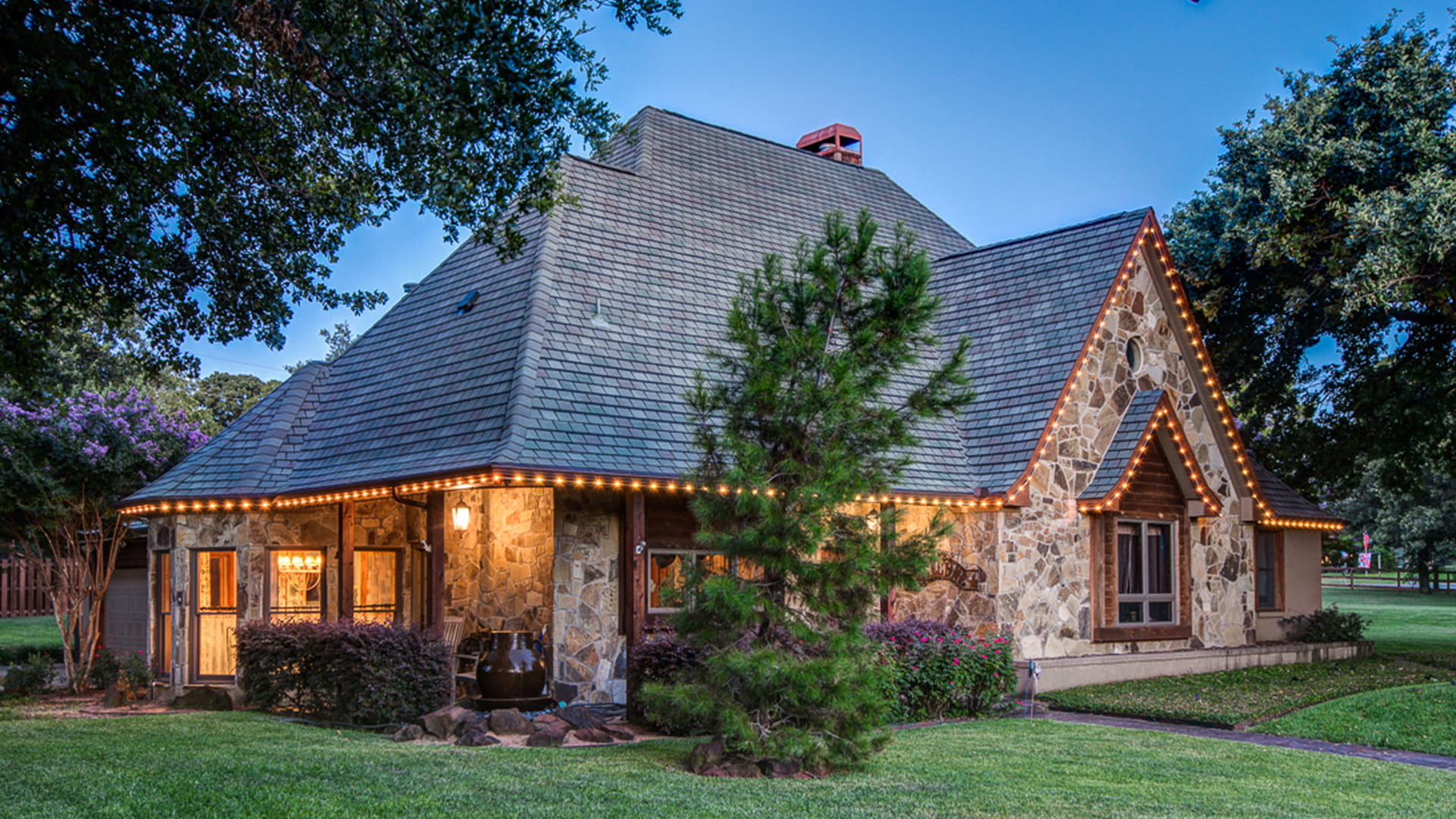 Warm white permanent roofline lighting highlighting the architecture of a home at night. Warm white permanent roofline lighting highlighting the architecture of a home at night.